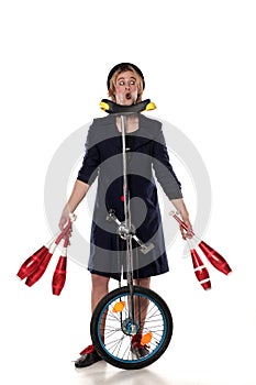 Clown with juggling clubs and a unicycle