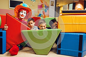 Clown and little boys hid behind the soft blocks
