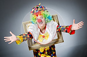 Clown with picture frame in funny concept