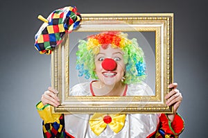 Clown with picture frame in funny concept