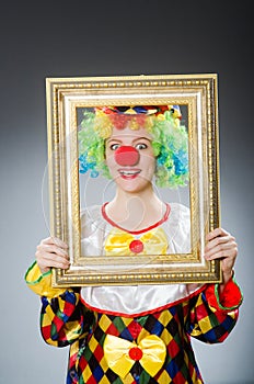 The clown with picture frame in funny concept