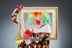 The clown with picture frame in funny concept