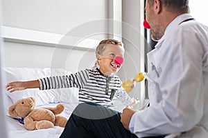 Clown therapy with happy child at hospital