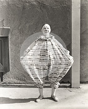 Clown wearing wide costume photo