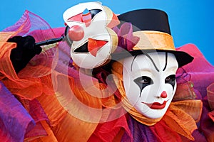 Clown in white mask performing