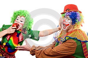 Clowns are fighting for an apple