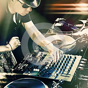 Club DJ playing mixing music on vinyl turntable
