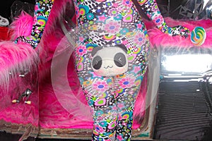 Club party blonde girl in acid anime style spandex catsuit with mirror car with pink fur ready for crazy clubbing life