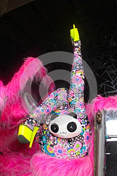 Club party blonde girl in acid anime style spandex catsuit with mirror car with pink fur ready for crazy clubbing life