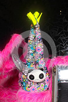 Club party blonde girl in acid anime style spandex catsuit with mirror car with pink fur ready for crazy clubbing life