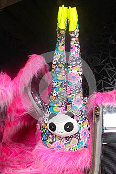 Club party blonde girl in acid anime style spandex catsuit with mirror car with pink fur ready for crazy clubbing life