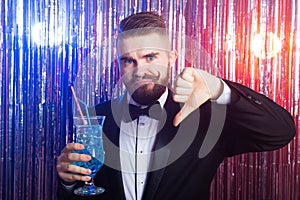 Club party, emotions and holidays concept - Portrait of elegant disappointed handsome man in a expensive suit holds blue
