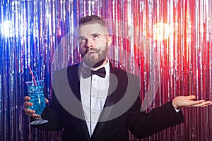 Club party, emotions and holidays concept - Portrait of elegant tired handsome man in a expensive suit holds blue