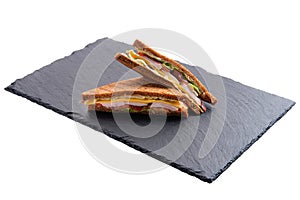 Club sandwich with ham, cheddar, cabbage and tomato isolated on white