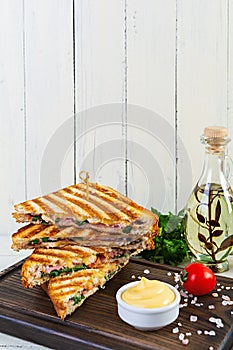 Club sandwich with ham, cheese, tomato, salad and chips