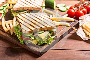 Club sandwich with tomatoes , cucumber , ham and cheese