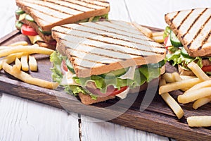 Club sandwich with tomatoes , cucumber , ham and cheese