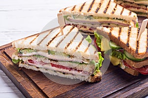 Club sandwich with tomatoes , cucumber , ham and cheese