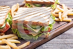 Club sandwich with tomatoes , cucumber , ham and cheese