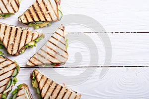 Club sandwich with tomatoes , cucumber , ham and cheese