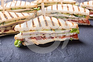 Club sandwich with tomatoes , cucumber , ham and cheese