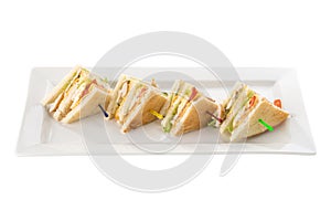 Club sandwiches with chicken, bacon, cheese and pickle isolated on white background