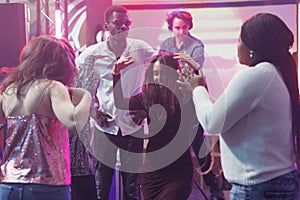 Clubbers dancing and having fun in club