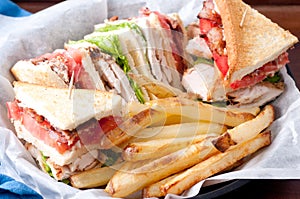 clubhouse sandwich with crispy fries