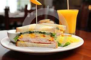 a clubhouse sandwich by a glass of orange juice, morning theme