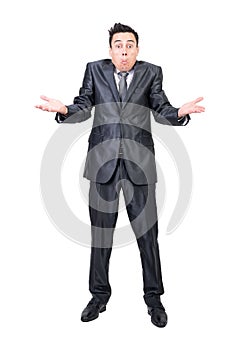 Clueless businessman shrugging shoulders against white background