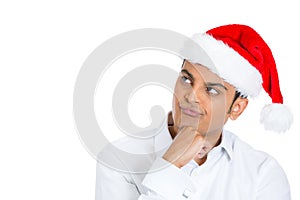 A clueless puzzled xmas man in red santa hat