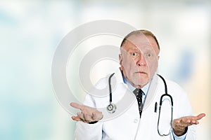 Clueless senior health care professional doctor shrug shoulders photo