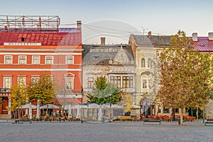 Cluj-Napoca city center. View from the Unirii Square to the Josika Palace and Wass Palace at sunrise on a beautiful, clear sky day