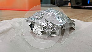 Clumps of aluminum foil on the table. photo