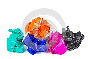 Clumps of crumpled colored paper on a white