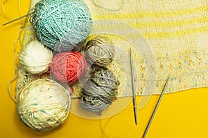 Clumps with yarn and threads on a yellow background. Handmade