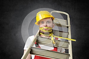 Clumsy worker with measure tape photo