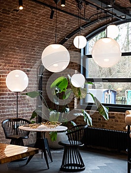 Cluster of glass pendant lights at the Tom Dixon flagship store and showroom at Coal Drops Yard, Kings Cross, London UK