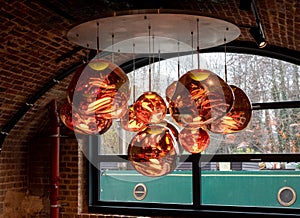 Cluster of glass pendant lights at the Tom Dixon flagship store and showroom at Coal Drops Yard, Kings Cross, London UK