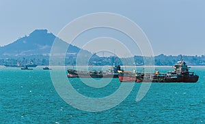 A cluster of local freighters moored offshore in the Singapore Straits in Asia