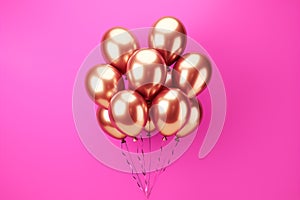 A cluster of pink and gold balloons floating in front of a pink backdrop