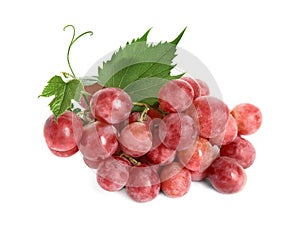 Cluster of ripe red grapes with green leaves on white background