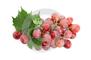 Cluster of ripe red grapes with green leaves on white background, top view