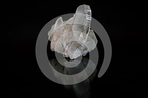 Cluster of transparent sparkling rock crystal with reflection, isolated.