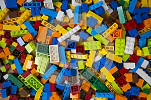 Cluttered pile of colorful toy construction bricks
