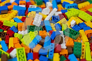 Cluttered pile of colorful toy construction bricks