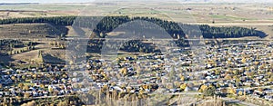 Clyde town an aerial view: Picturesque, lush greenery, houses, trees, nestled by a mountain.