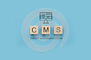 CMS Content Management System banner. CMS Block letters on blue background. Cms written on a wooden cubes. website management