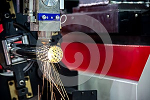 The CNC fiber laser cutting machine cutting the stainless pipe