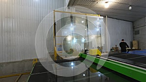 CNC glass cutting machine at work. Automatic cutting of the glass on the table.